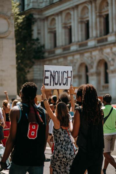 people holding a sign at a protest